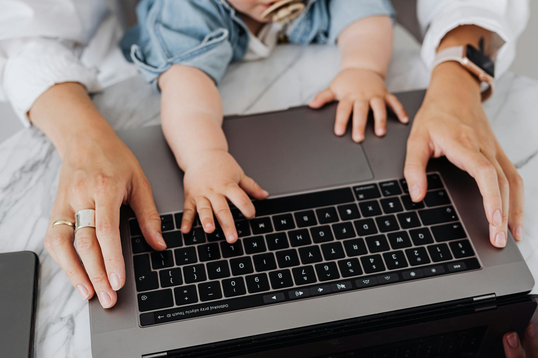 a person using black and silver laptop- baby bottle warmer